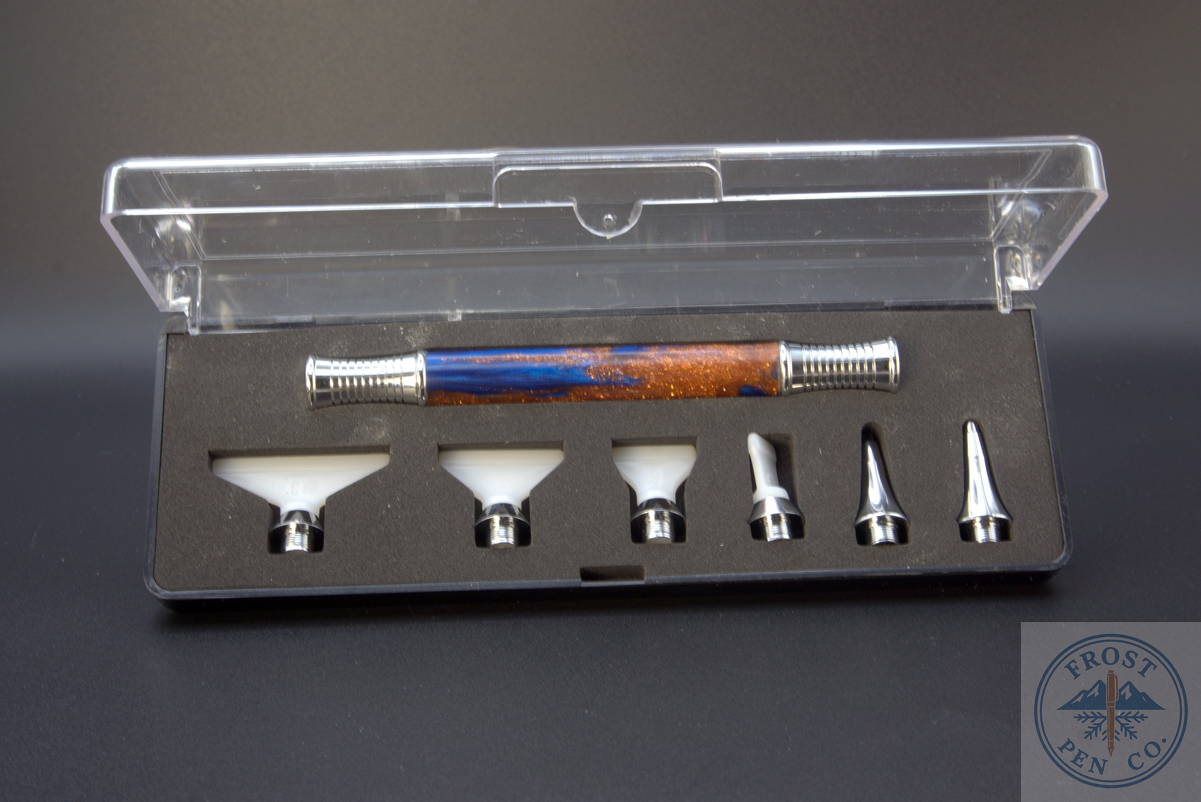 Set of Diamond Painting attachments in a clear plastic case on a gray background