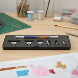 Cross-stitching tools and materials on a wooden table